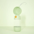 Portable light green pet water bottle with lanyard and orange button control - Water + Food Storage / Green