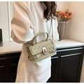 Light green crocodile texture crossbody bag with silver buckle on a stylish model - Green