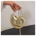 Detail of gold nautilus clutch with metallic mirror finish and radial texture - Gold