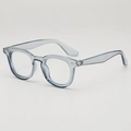 Retro ronde transparant grijs-blauwe brilmontuur met elegante metalen klinknagel accenten - Transparant Grijs