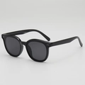 Classic black wide-frame kids sunglasses with UV400 lenses shown at a 45-degree angle - Black Frame