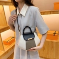 Elegante driekleurige handtas in crème, bruin en zwart met ronde handgreep bovenop - Zwart Color Block