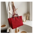 Large red tweed tote bag with leather handles and silver chain strap on a wooden rack - Red