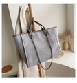 Gray woven texture tote bag with chain strap displayed on a wooden rack - Light Gray