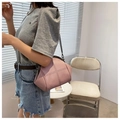 Pink shell crossbody bag with metal chain strap and doctor bag closure shown on model - Pink
