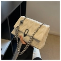 White quilted flap bag with V-pattern stitching and black U-lock chain strap - White