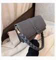 Grey PU leather crossbody bag featuring a thick braided handle and gold hardware - Gray