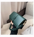 Fashionable dark green leather crossbody bag with distinctive woven handle and belt buckle - Green