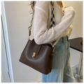 Detailed close-up of brown PU leather bag with black and white wavy wide strap - Brown