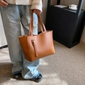 Caramel brown leather tote bag with elegant vertical straps and gold buckle details - Brown