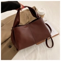 Detail of dark brown faux leather handbag with lychee texture and vertical stitching - Brown
