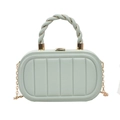 Detail of mint green box bag with vertical textures, twisted handle and gold chain - Green
