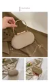 Detailed macro view of the gold sequined evening clutch bag with butterfly clasp - Gold