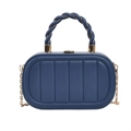 Close-up of dark blue quilted box bag with golden twisted handle and metal chain - Blue