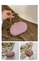 Pink glitter evening clutch bag with gold bow clasp and metallic arc handle detail - Pink