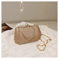Close-up of gold sequin evening clutch with rhinestone ring handle and chain strap - Gold