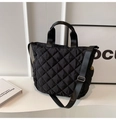 Black quilted tote bag with diamond stitching, side pockets, and adjustable shoulder strap - Black
