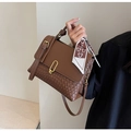 Brown woven shoulder bag with a silk scarf handle and golden horseshoe hardware - Brown
