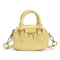 Mini yellow crossbody bag with silver bow accent and round top handle in PU leather - Yellow