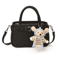 Black leather tote bag with decorative buckle straps and cute teddy bear pendant charm - Black