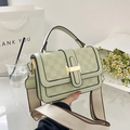 Detail of mint green plaid embossed crossbody bag with wide woven strap and gold buckle - Green