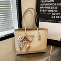 Large beige woven tote bag with silk scarf bow accent and faux leather trim for women - Apricot