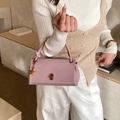 Elegant mauve leather handbag for women featuring gold star pendant and knot handle detail - Purple