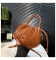 Brown pleated leather handbag with top handle and adjustable shoulder strap in minimal setting - Dark Brown