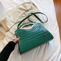 Green crocodile pattern crossbody bag with gold lip-shaped handle and red lip detail - Green