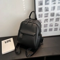 Minimalist black pebble grain leather backpack with dual zippers and front flap pocket - Black