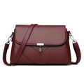 Fashionable wine red crossbody bag with lychee texture and leaf pendant detail - Burgundy