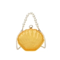 Elegant amber transparent shell clutch bag with pearl handle and detachable chain strap - Yellow