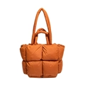 Bright orange quilted puffer tote bag with padded texture and dual handles - Burnt Orange