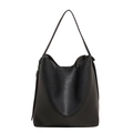 Minimalist black pebbled leather tote bag with wide shoulder strap in front view - Black