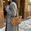 Brown rivet cloud bag with metal chain strap shown in a cozy outdoor winter setting - Brown