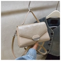 Detail of beige structured handbag featuring striped texture and oval metallic clasp - Khaki