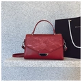 Minimalist red leather crossbody bag with silver hardware on a marble surface - Red
