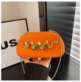Detail of orange hard-shell handbag with golden wave-shaped metal buckle and chain strap - Orange