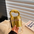 Golden cylindrical metal clutch bag with unique streamlined handle and chain strap - Cylindrical Shape / Gold