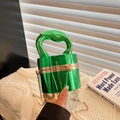 Metallic green cylindrical evening bag with gold chain and unique sculptural top handle - Cylindrical Shape / Green