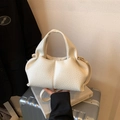 Chic white lychee grain hobo bag with pleated texture and gold hardware on books - White