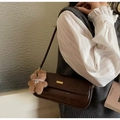 Dunkelbraune glänzende Baguette-Tasche mit Plüschbär-Anhänger und Goldakzenten - Kaffee ohne Anhänger