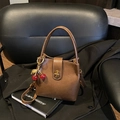 Retro brown bucket bag with cherry charm on black leather chair and blazer - Without Pendant / Brown