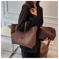 Close-up of the pebbled leather texture and matching inner pouch of the brown tote bag - Brown