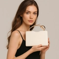 Detail of elegant cream PU evening clutch with golden tulip shaped metal handle - Off White