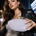 Macro detail of purple sequin evening clutch bag with gold metallic capsule clasp - White Sequin