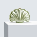 Close-up of pearlescent green shell-shaped acrylic evening clutch with gold metal clasp - Light Green