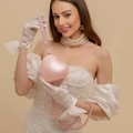 Elegant pink heart-shaped acrylic clutch bag with pearl chain shown with fashion model - Pink