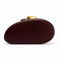 Detailed shot of dark red pebble-shaped evening bag with gold and silver metal clasps - Burgundy
