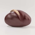 Detailed view of the organic shell-shaped burgundy evening clutch with golden metal clasp - Burgundy